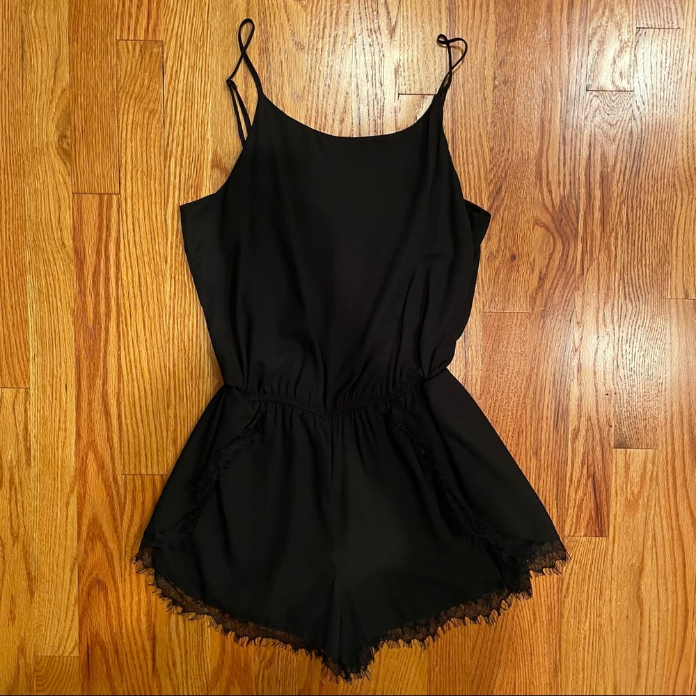 Aqua black romper with lace trim around hem